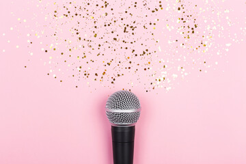 ASMR, karaoke, singing, recording concept.  A microphone on blue background and spilling out gold...