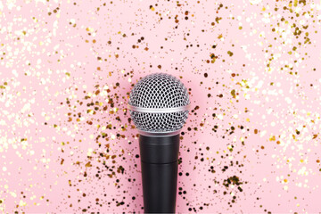 ASMR, karaoke, singing, recording concept.  A microphone on blue background and falling gold...