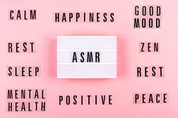 The lamp with letters ASMR on pink background. Sound and visual practice for anxiety, stress and...