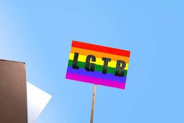 Holding a banner with the lesbian, gay, bisexual and transgender LGBT rainbow flag. LGBT equal rights movement and gender equality concept.