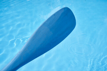 blue paddle blade over the water
