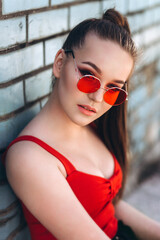 Beautiful woman natural pretty face casual female portrait lifestyle beauty girl in red sun glasses outdoors