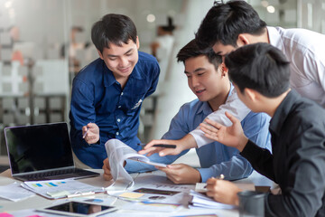 Meeting of young asian business people who are committed to work. Creative business team sitting working together at office.
