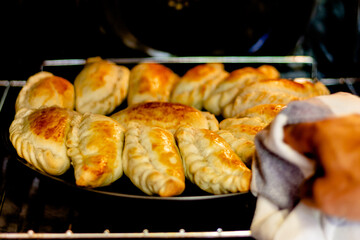 Latin man's hand preparing typical Argentine and South American pastries, 