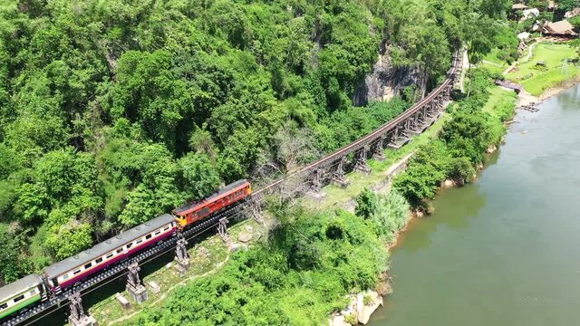 4K resolution pf train on Death Railway bridge over the Kwai Noi River at Krasae cave in Kanchanaburi province, Thailand