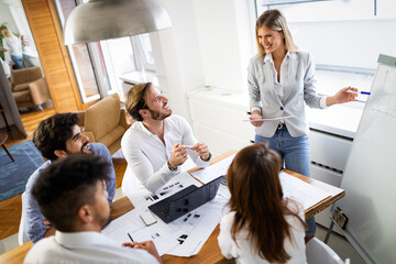 Team of architects working on construction plans in office