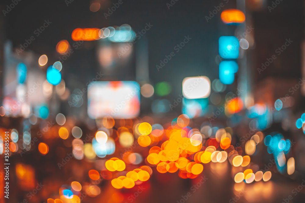 Wall mural Bokeh abstract blur from street or road lights and car at night of the city or town.