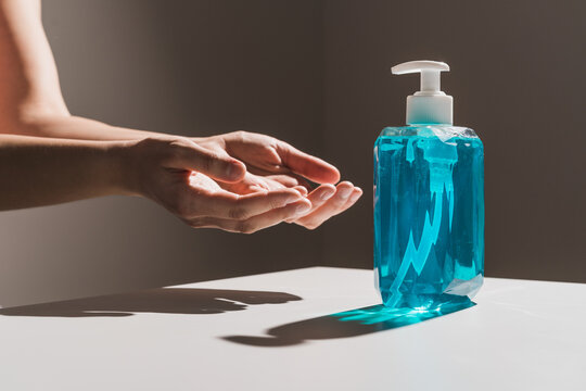 Flow of blue liquid soap coming out of dispenser