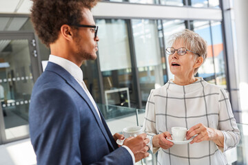 Two business people make small talk in the office