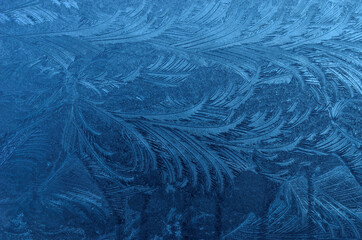 Fototapeta na wymiar beautiful ice flower shapes and patterns on frost frozen window