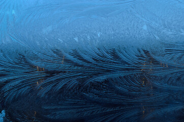 beautiful ice flower shapes and patterns on frost frozen window