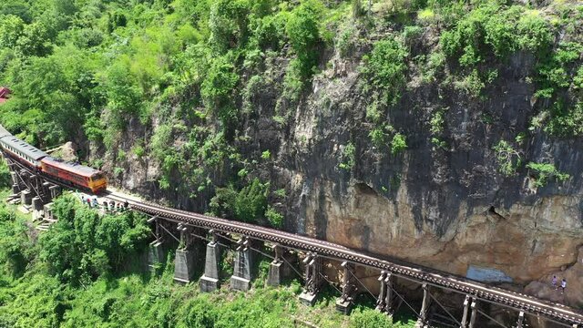 4K resolution pf train on Death Railway bridge over the Kwai Noi River at Krasae cave in Kanchanaburi province, Thailand