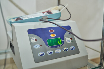 Closeup of blood collection mixer machine indicating volume of donor blood in medical laboratory