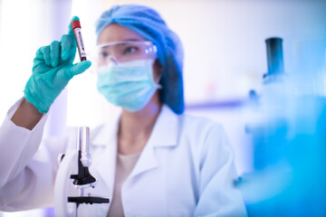Fototapeta premium The scientist doctor created a vaccine against the coronavirus.Coronavirus 2019-nCoV Blood Sample. virus outbreaking.Technician holding blood tube test in the research laboratory