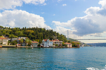 Fototapeta premium Sunny landscape with bright houses over the water edge of the Bosphorus Strait in Istanbul, Turkey