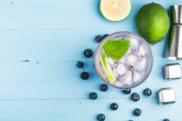 Summer refreshment drinks, Blueberry Lemonade or mojito cocktail with lemon, fresh blueberries and mint,