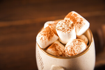 Concept with marshmallows in a circle on a dark background. Autumn, coffee, tea, mug, marshmallows, cozy. Fall concept closeup and copy space on dark background.