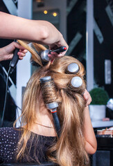 Fototapeta premium hair styling for a woman in a female hairdresser
