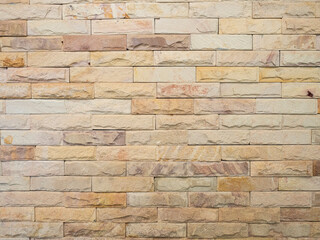 Light brown brick stone wall texture. For background.