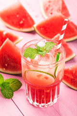 Watermelon summer cocktail with ice and mint leaves.