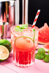 Watermelon summer cocktail with ice and mint leaves.