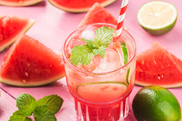 Watermelon summer cocktail with ice and mint leaves.