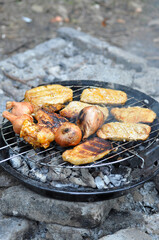 grilled chicken,onion,steaks and bread on the grill