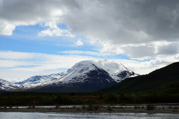 majestic snowy mountain and river landscape in early summer