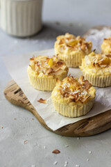 Gluten free cheesecake cupcakes with coconut flakes  