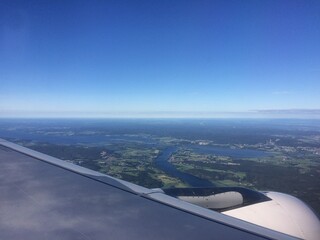 Fototapeta na wymiar View from the plane window on the Norwegian lakes and fields