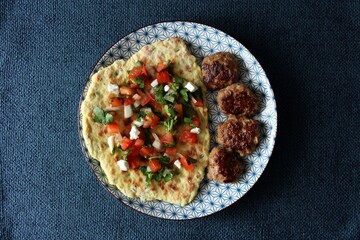 Greek grill meatball on pita with tomato and cucumbers