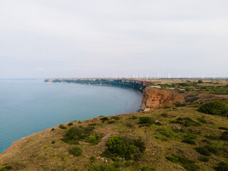 Fototapeta na wymiar Aerial view landscape of headland sea and wind turbines background