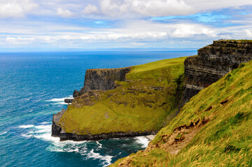 Fototapeta na wymiar Spectacular view of the Cliffs of Moher (Aillte an Mhothair), edge of the Burren region in County Clare, Ireland. Great touristic attraction