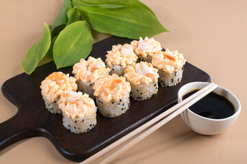 Sushi Roll with yellow cream sauce on beige background