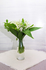 lily on wooden background. Bouquet of flowers in a vase