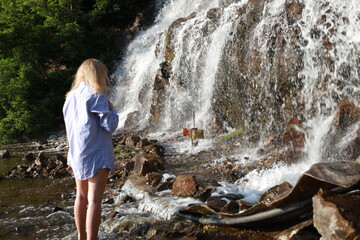 young woman in the waterfall