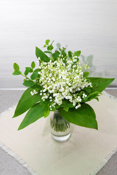 lily on wooden background. Bouquet of flowers in a vase