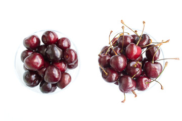 Set of ripe cherries with a twig and without. Red cherries isolated on a white cutout.