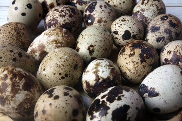 organic quail eggs in wooden tray