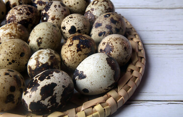 organic quail eggs in wooden tray