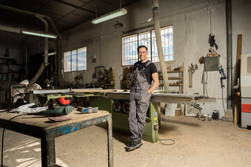 Worker looking at camera smiling in a factory.
