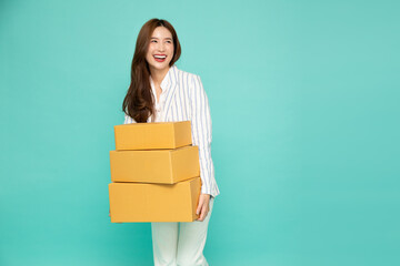 Happy Asian woman holding package parcel box isolated on light green background, Delivery courier and shipping service concept