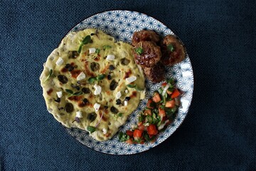 Greek grill meatball on pita with tomato and cucumbers