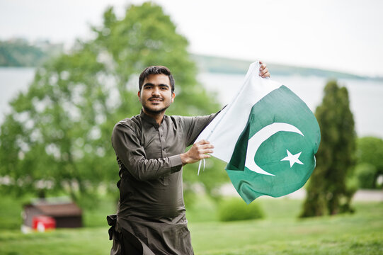 Indo pakistani man wear traditional clothes achkan or sherwani with Pakistan flag.