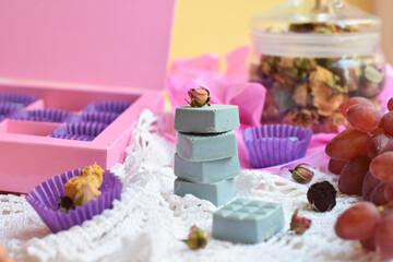 Romantic composition of handmade sweets and dry rosebuds. Vintage style.