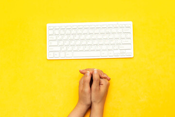 Modern aluminum computer keyboard isolated on yellow background