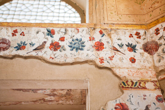 Faded frescoes from 17th century inside the historical Hasht Behesht Palace in Isfahan, Iran