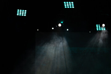 Theater lights spotlights and smoke over the stage, texture background for design.