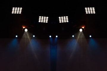 Theater lights spotlights and smoke over the stage, texture background for design.