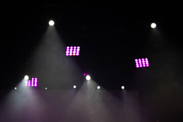 Theater lights spotlights and smoke over the stage, texture background for design.